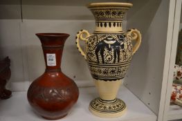 A pottery vase with incised decoration together with an Egyptian twin handled pottery vase.