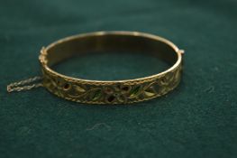 An engraved gilt metal bangle.