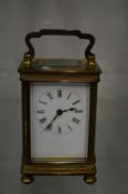 A brass carriage clock.