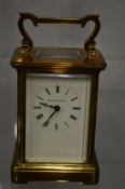 A brass carriage clock.