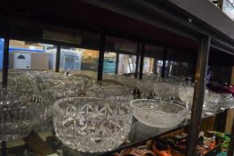 A large quantity of cut glass bowls and other items.