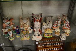 A good collection of Staffordshire items to include a large spaniel jug, flat back figure groups,