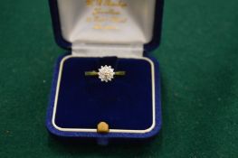 An 18ct gold and diamond cluster ring, size N½.