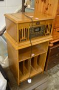 A combination record player and compact disc player in a retro cabinet on stand.