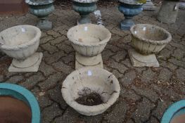A set of three reconstituted stone pedestal planters together with a matching top section.
