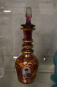 An Islamic gilt decorated amethyst colour decanter and stopper.