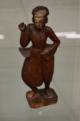 An Eastern carved wood figure.