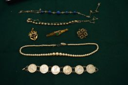 Two decorative seed pearl mounted gilt metal pendants/brooches, a bar brooch a bracelet, a coin