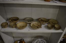 A collection of studio pottery slip ware dishes.
