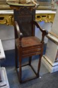 A child's 17th century style oak high chair.