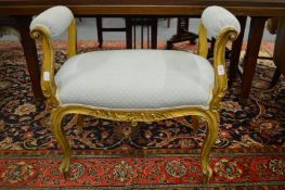 A small gilt wood window seat.