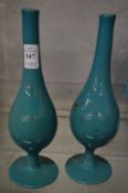 A pair of gilt decorated turquoise opaque glass bottle vases.