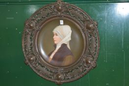 A large Continental circular porcelain charger mounted in a decorative cast metal frame with pierced
