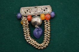 Decorative Eastern silver and hard stone pendant.