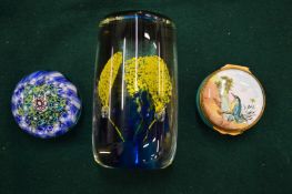 Two glass paperweights and an enamel pill box.