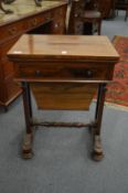 A 19th century rosewood combination writing and work table with folding top, single drawer above a