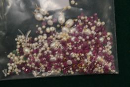 Loose natural pearls and rubies.