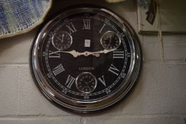 A large multi-dial circular wall clock.