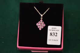 A decorative silver and pink stone pendant and chain.