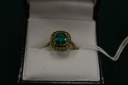 A 9ct gold ring set with central green stone, size M.