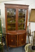 An Edwardian inlaid mahogany cupboard bookcase.