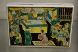 A Chinese famille verte porcelain brick decorated with a ceremonial scene.