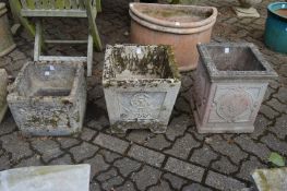 Three reconstituted stone square shaped planters.