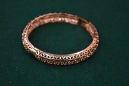 A pierced gilt metal and diamante bracelet.