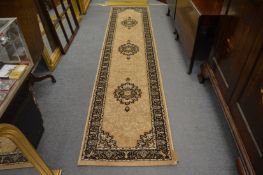 A modern machine made Persian design runner, beige ground with floral decoration 320cm x 70cm.
