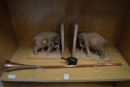 A hunting horn, elephant book ends and another elephant.