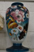 A large floral decorated opaque glass vase.