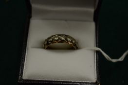 A gold and cubic zirconia ring, size N.