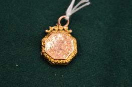 A 9ct gold engraved locket.