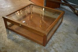 An oak framed table top display cabinet.