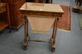 A 19th century rosewood work table with bobbin turned supports.