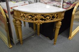 A carved gilt wood and marble top corner console table.