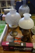 Three oil lamps with accessories.