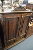 An Eastern hardwood cabinet with two doors enclosing numerous small drawers above two further