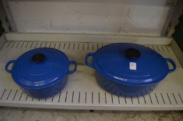 Two Le Creuset blue enamel cast iron dishes with covers.