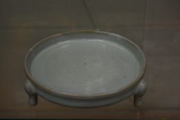 A Chinese celadon glazed circular brush washer.