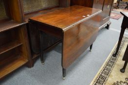 A George III mahogany drop-flap gate-leg dining table.