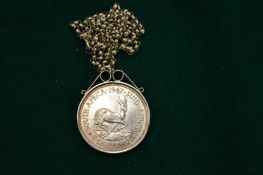 A South African 1947 five shilling coin mounted on a silver chain.
