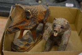 Carved wood model of a boar and a bear.