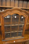 An oak hanging display cabinet.