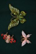 Three decorative butterfly and bug brooches.