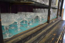 A large quantity of cut glass drinking glasses.