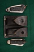 Leather belt pouch containing two army knives.