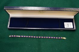 A good 9ct gold diamond and amethyst bracelet, boxed.