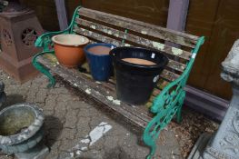 A cast metal and wooden slatted garden bench.