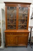 An Edwardian inlaid mahogany cupboard bookcase.